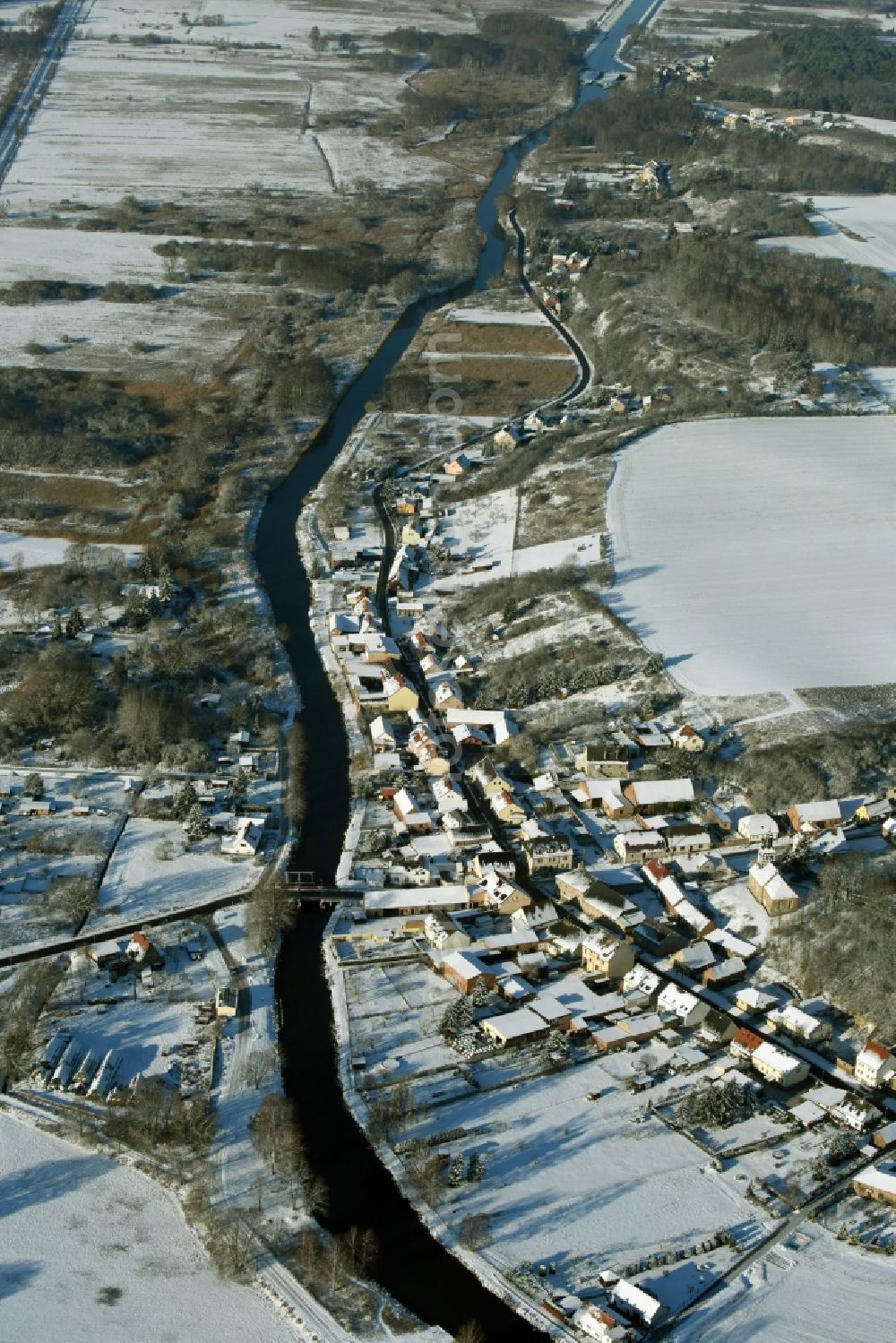 Aerial image Niederfinow - View of the snow-covered winterly village of Niederfinow along the river of Old Finow in the state of Brandenburg