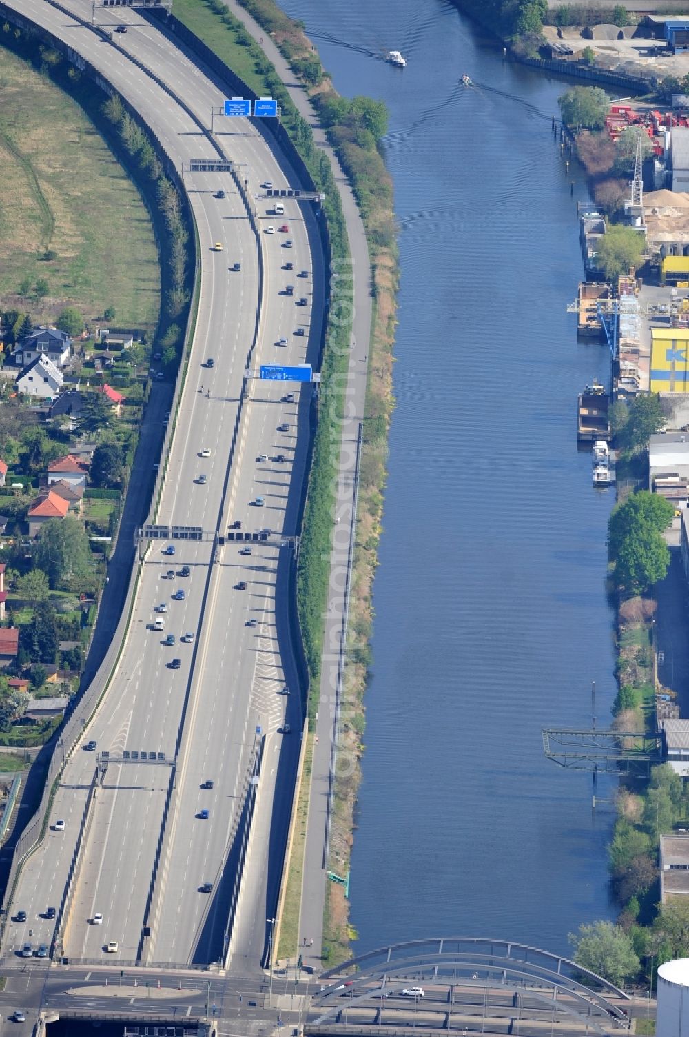 Berlin from above - The course of the E35 motorway / A113 along the Teltow canal at the Ernst-Ruska-Ufer in Berlin Adlershof. The newly built highway runs along the former border / border strip between Adlershof and Rudow