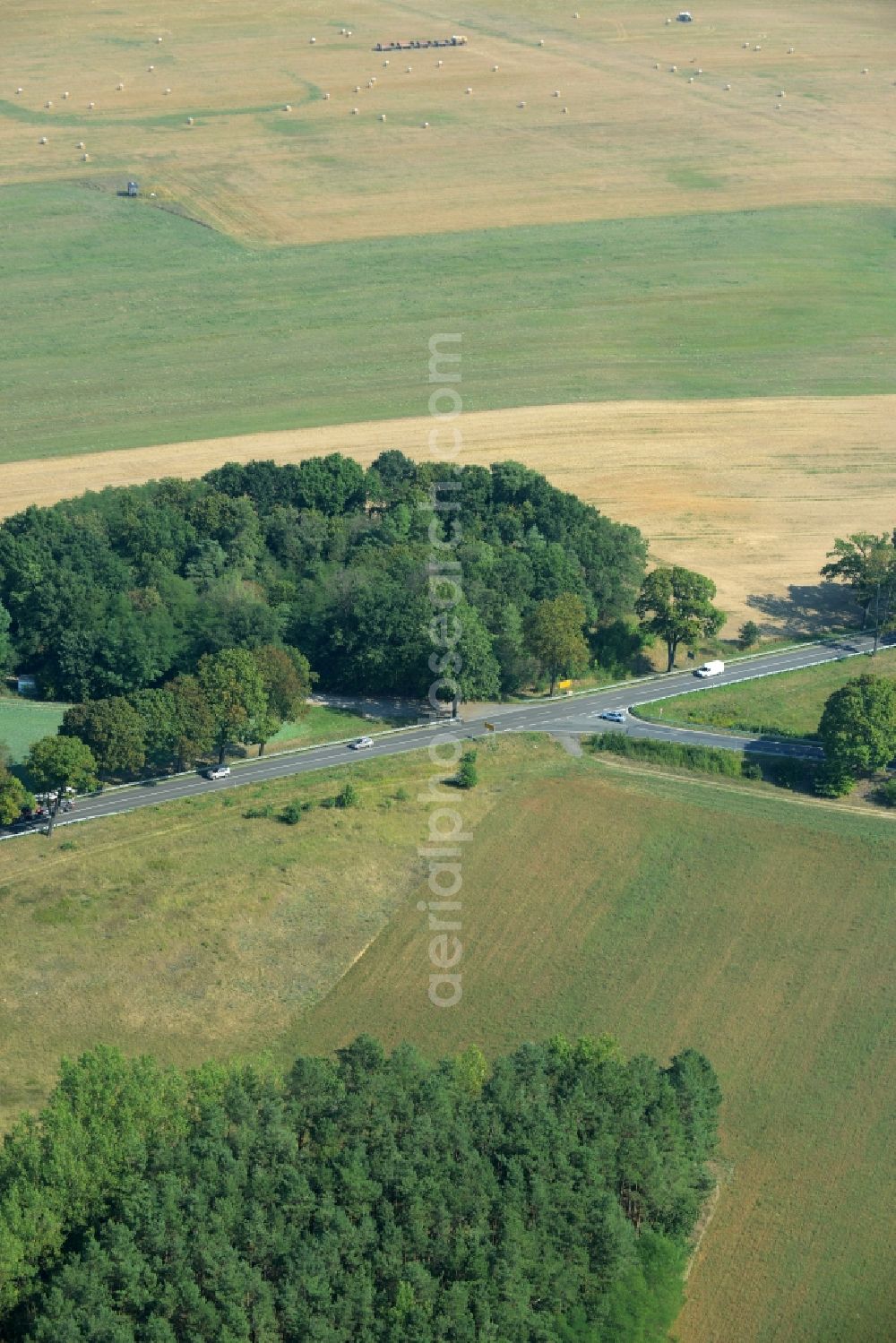 Rehfelde from above - Crossroads of federal highway B1/B5 and county road L385 in Rehfelde in the state of Brandenburg. The road is taking its course amidst fields and wooded areas