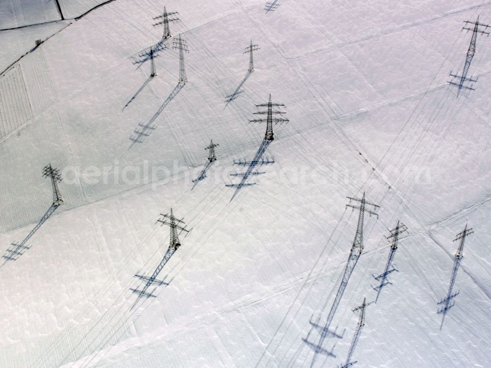 Heilbronn from above - Snow covered transmission lines and acres in the county district of Heilbronn in the state of Baden-Württemberg. The high voltage power lines are set up along the fields and acres in the district and the region. The different sizes, geometries and structures of the various fields in winter are still very well visible