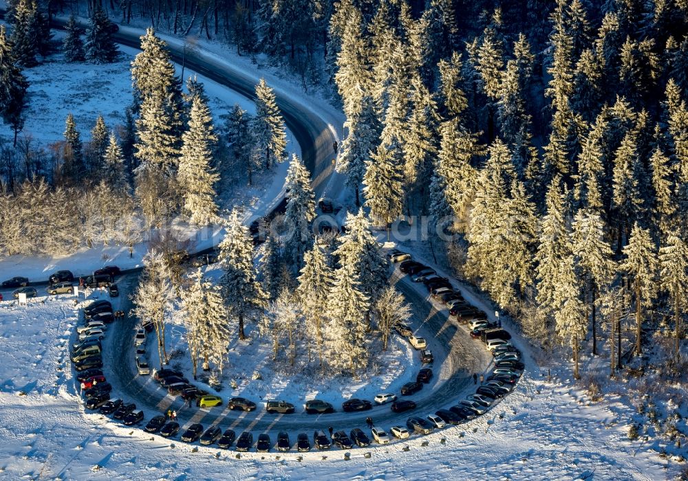 Winterberg from the bird's eye view: Plateau and landscape on the snow-covered mountain Kahler Asten in Winterberg in the state of North Rhine-Westphalia. The mountain is the third highest in the Rothaar Mountain Range region. On top of the mountain sits the hotel-restaurant and the green tower. It is also part of the winter sports resort of Skiliftkarussell Winterberg