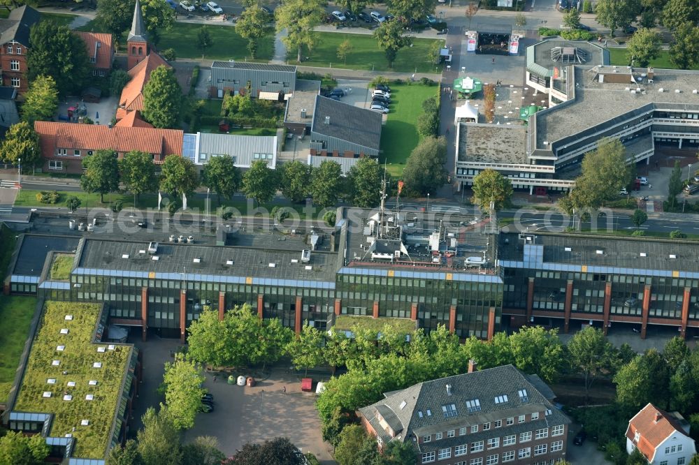 Aurich from the bird's eye view: Administrative building of the State Authority administrative district Aurich and the motor vehicle registration office next to the shoppingcentre Carolinen Hof in Aurich in the state Lower Saxony