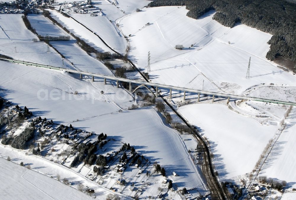 Aerial photograph Wolfsberg - Wintry snowy viaduct of the railway bridge structure to route the railway tracks in Graefinau-Angstedt in the state Thuringia