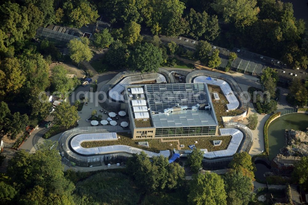 Berlin from above - Bird house on the Zoo grounds in Berlin in Germany. The building with the bent front and glass roof is located in the Northwestern corner of the park