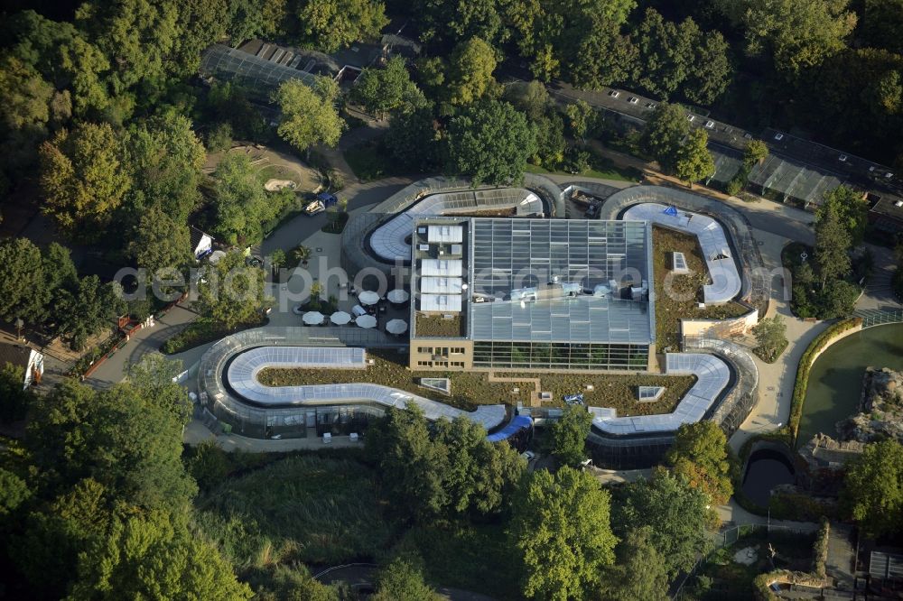 Berlin from the bird's eye view: Bird house on the Zoo grounds in Berlin in Germany. The building with the bent front and glass roof is located in the Northwestern corner of the park