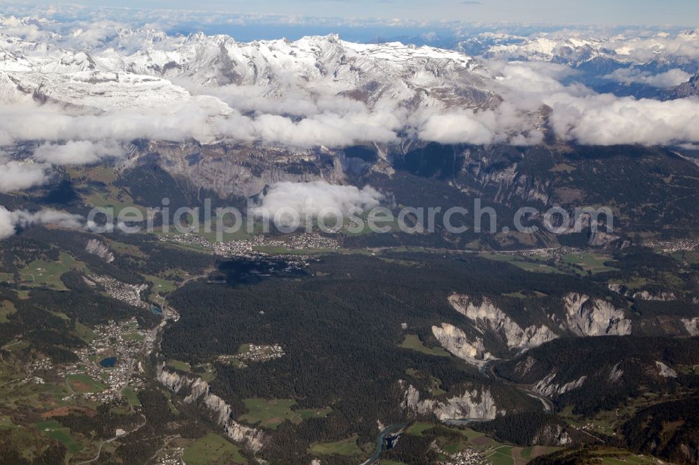 Aerial image Laax - Snow covered mountains in the Swiss Alps and landscape in the valley at Laax and Flims in the canton Graubuenden, Switzerland