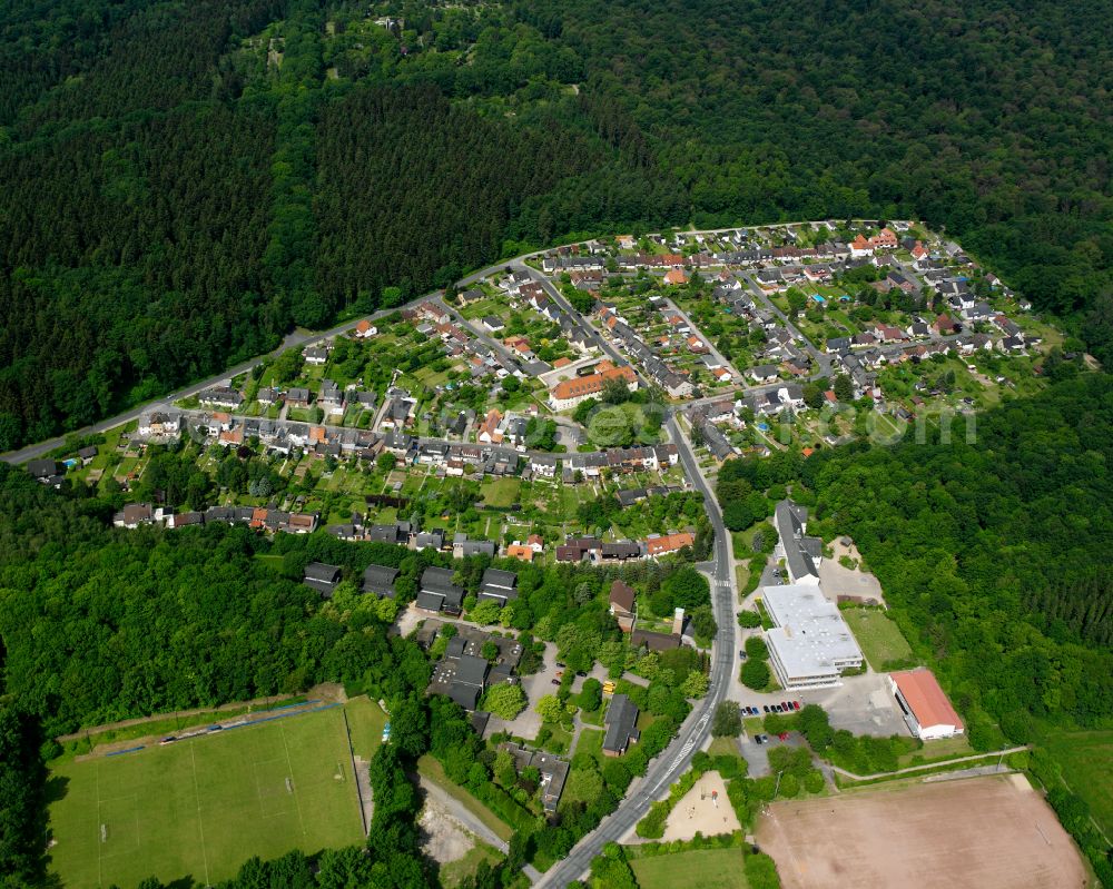 Bad from the bird's eye view: Surrounded by forest and forest areas center of the streets and houses and residential areas in Bad in the state Lower Saxony, Germany