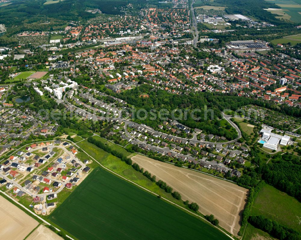 Bad from the bird's eye view: Surrounded by forest and forest areas center of the streets and houses and residential areas in Bad in the state Lower Saxony, Germany