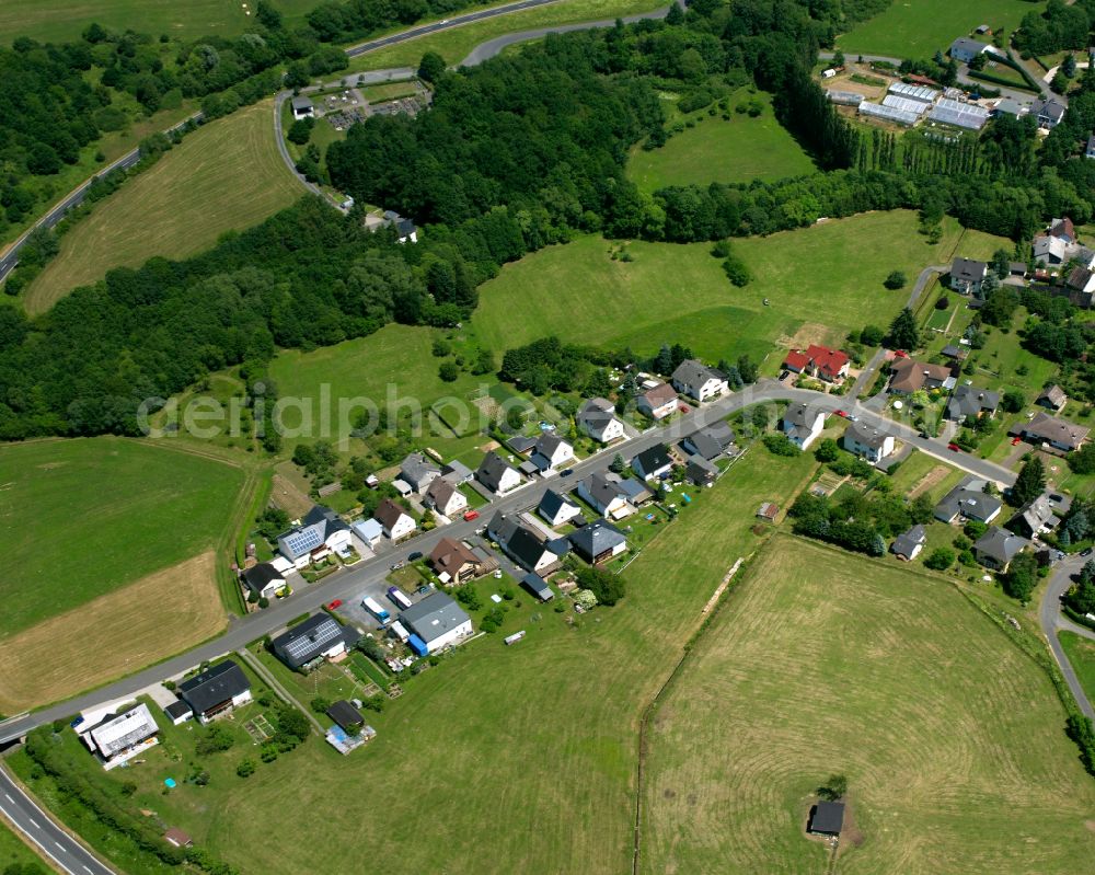 Aerial photograph Beilstein - Surrounded by forest and forest areas center of the streets and houses and residential areas in Beilstein in the state Hesse, Germany