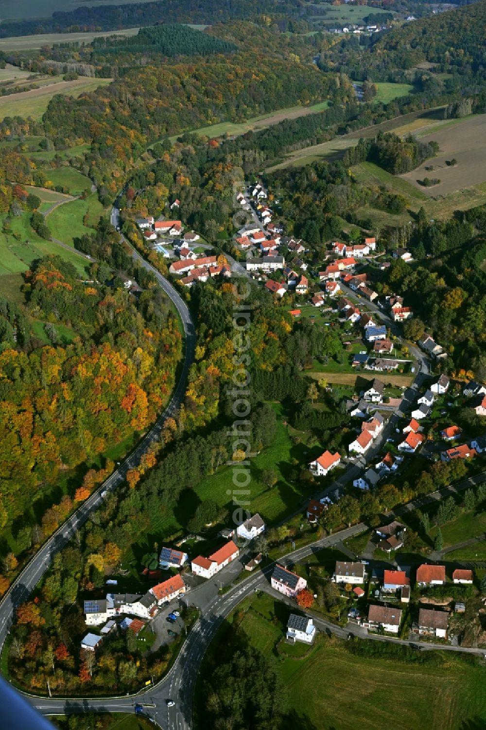 Bledesbach from above - Surrounded by forest and forest areas center of the streets and houses and residential areas in Bledesbach in the state Rhineland-Palatinate, Germany