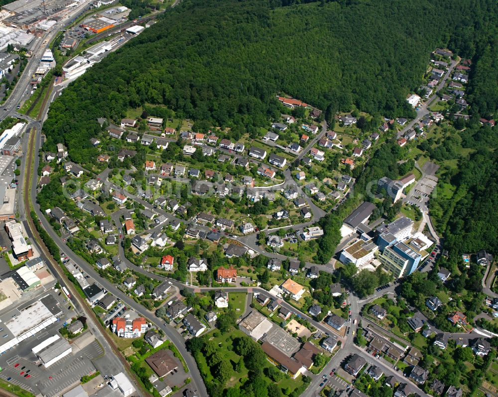 Dillenburg from above - Surrounded by forest and forest areas center of the streets and houses and residential areas in Dillenburg in the state Hesse, Germany