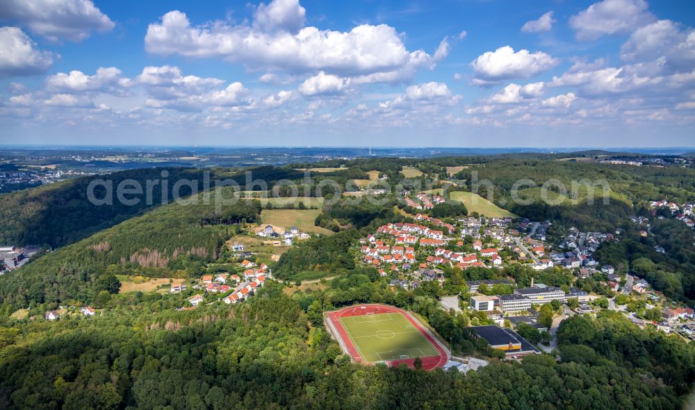 Ennepetal from the bird's eye view: Surrounded by forest and forest areas center of the streets and houses and residential areas in Ennepetal in the state North Rhine-Westphalia, Germany