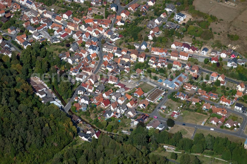 Frammersbach from above - Surrounded by forest and forest areas center of the streets and houses and residential areas in Frammersbach in the state Bavaria, Germany