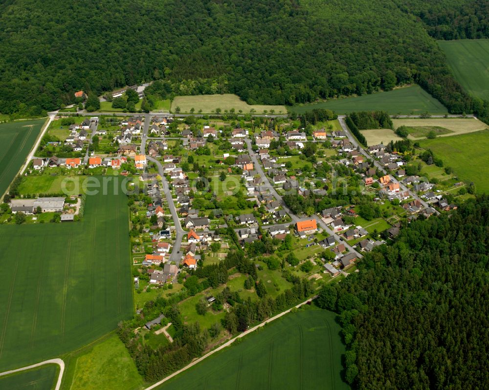 Heimerode from above - Surrounded by forest and forest areas center of the streets and houses and residential areas in Heimerode in the state Lower Saxony, Germany