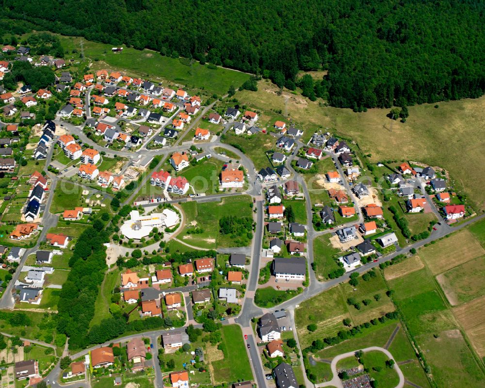 Manderbach from above - Surrounded by forest and forest areas center of the streets and houses and residential areas in Manderbach in the state Hesse, Germany