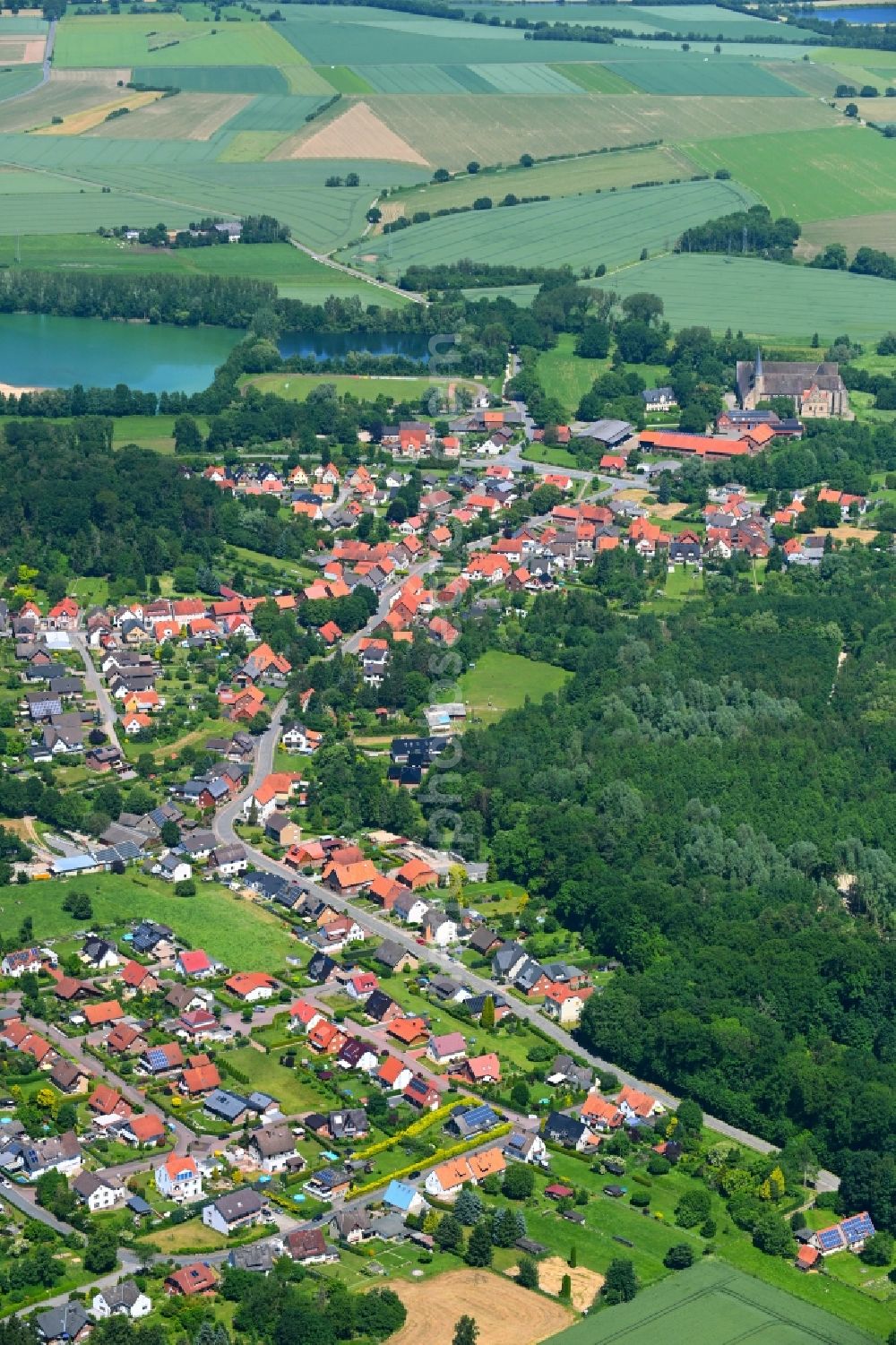 Möllenbeck from above - Surrounded by forest and forest areas center of the streets and houses and residential areas in Moellenbeck in the state Lower Saxony, Germany