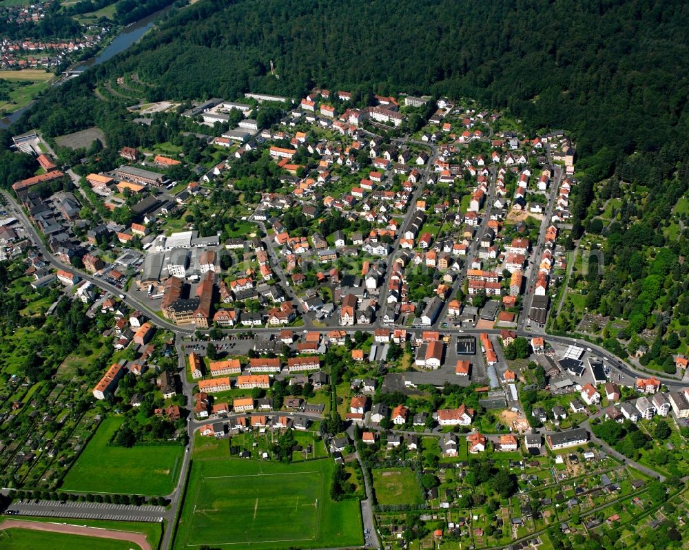 Neumünden from above - Surrounded by forest and forest areas center of the streets and houses and residential areas in Neumünden in the state Lower Saxony, Germany