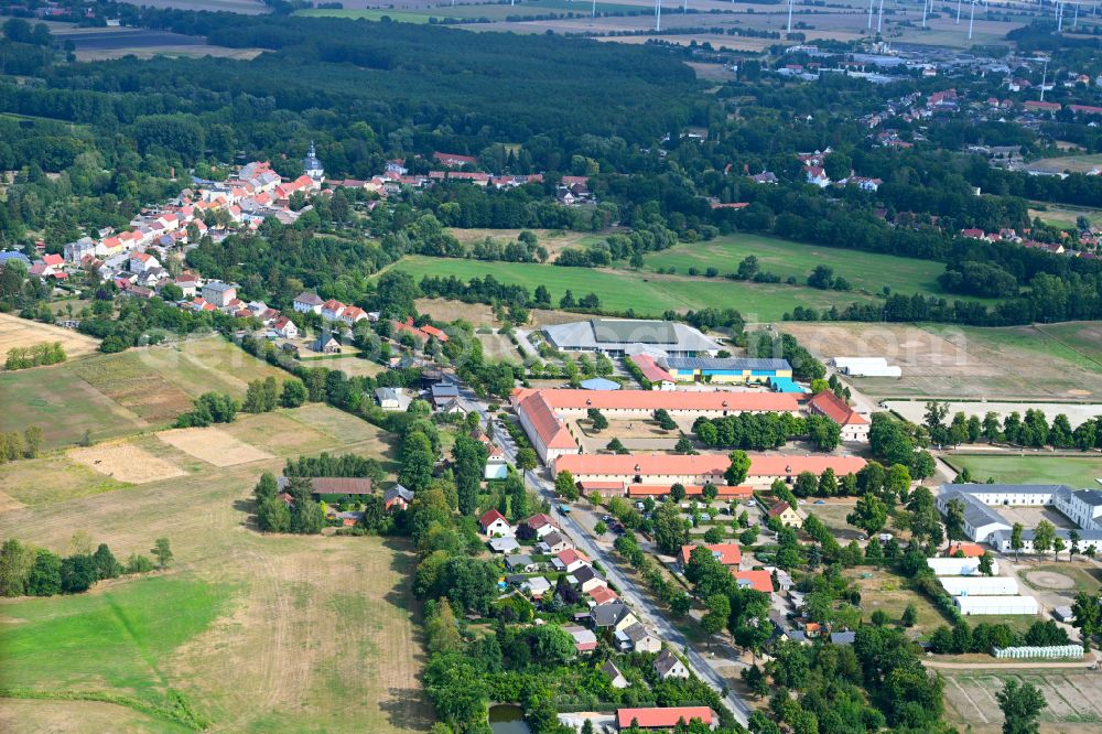 Aerial photograph Neustadt (Dosse) - Surrounded by forest and forest areas center of the streets and houses and residential areas in Neustadt (Dosse) in the state Brandenburg, Germany