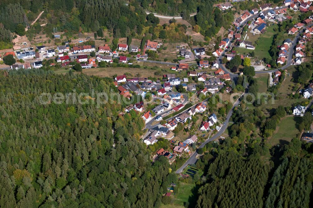 Aerial image Rieneck - Surrounded by forest and forest areas center of the streets and houses and residential areas in Rieneck in the state Bavaria, Germany