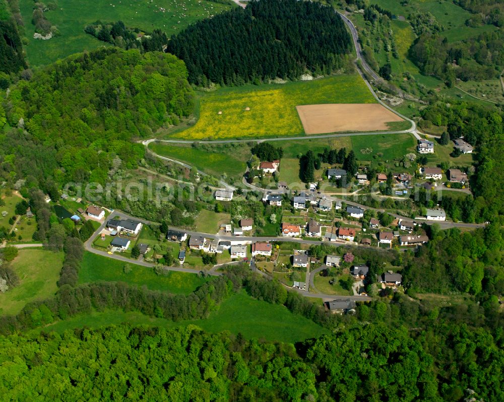 Schönbach from above - Surrounded by forest and forest areas center of the streets and houses and residential areas in Schönbach in the state Hesse, Germany