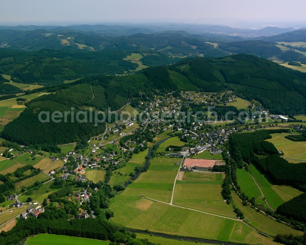 Aerial image Schwarzenau - Surrounded by forest and forest areas center of the streets and houses and residential areas in Schwarzenau in the state North Rhine-Westphalia, Germany