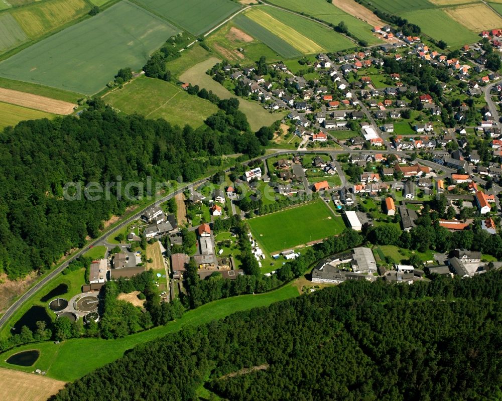 Aerial photograph Uschlag - Surrounded by forest and forest areas center of the streets and houses and residential areas in Uschlag in the state Lower Saxony, Germany