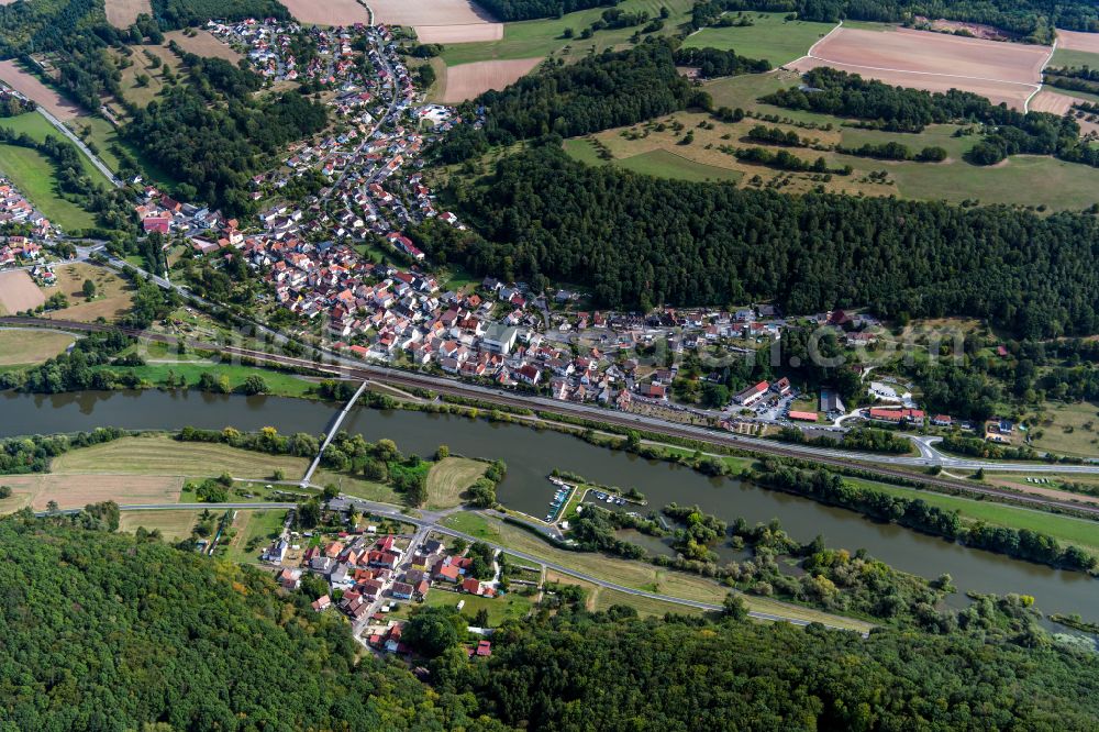 Wernfeld from the bird's eye view: Surrounded by forest and forest areas center of the streets and houses and residential areas in Wernfeld in the state Bavaria, Germany