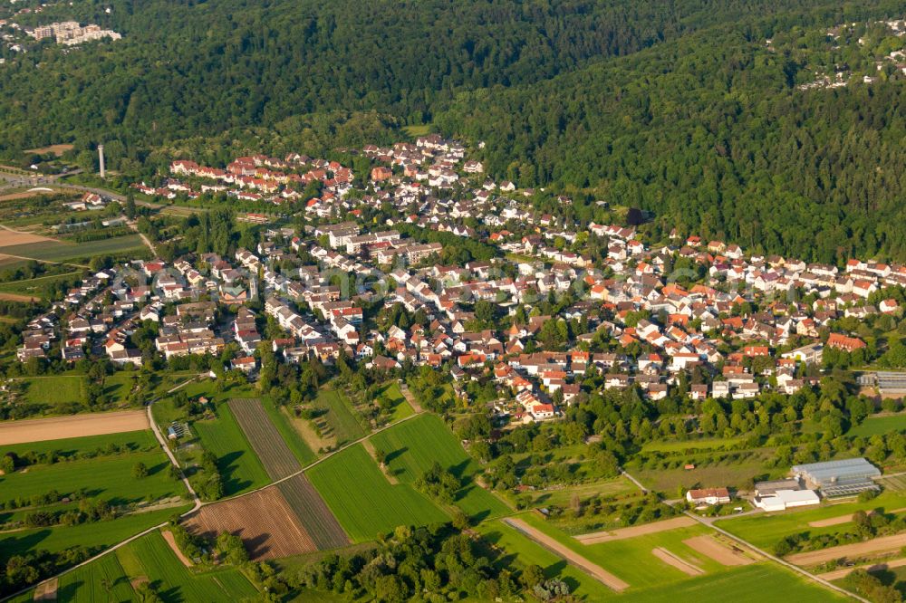 Aerial image Wolfartsweier - Surrounded by forest and forest areas center of the streets and houses and residential areas in Wolfartsweier in the state Baden-Wuerttemberg, Germany