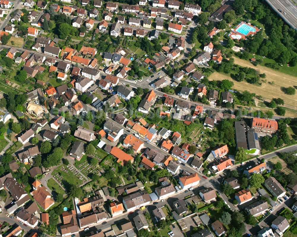 Wolfartsweier from above - Surrounded by forest and forest areas center of the streets and houses and residential areas in Wolfartsweier in the state Baden-Wuerttemberg, Germany