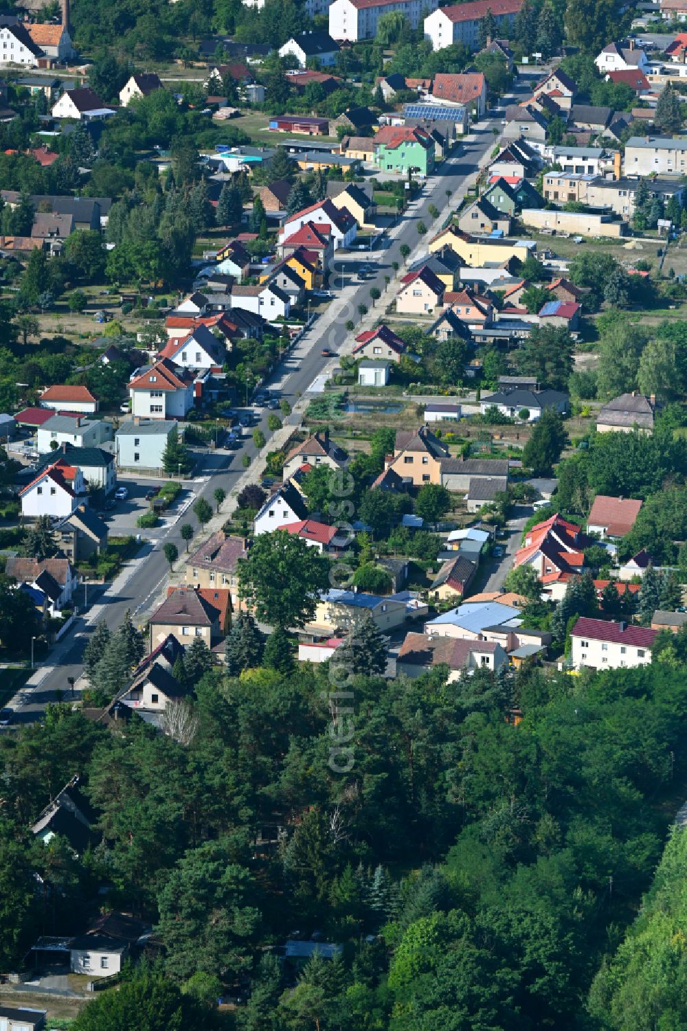 Crinitz from the bird's eye view: Urban area with outskirts and inner city area surrounded by woodland and forest areas on street Hauptstrasse in Crinitz in the state Brandenburg, Germany