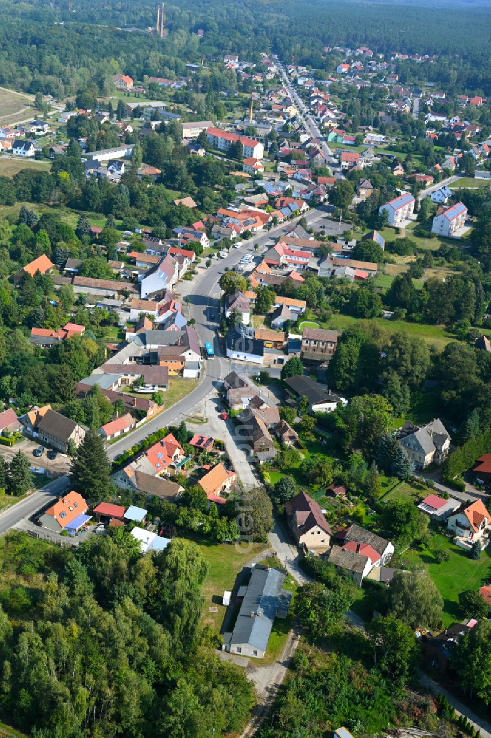 Aerial image Crinitz - Urban area with outskirts and inner city area surrounded by woodland and forest areas on street Hauptstrasse in Crinitz in the state Brandenburg, Germany