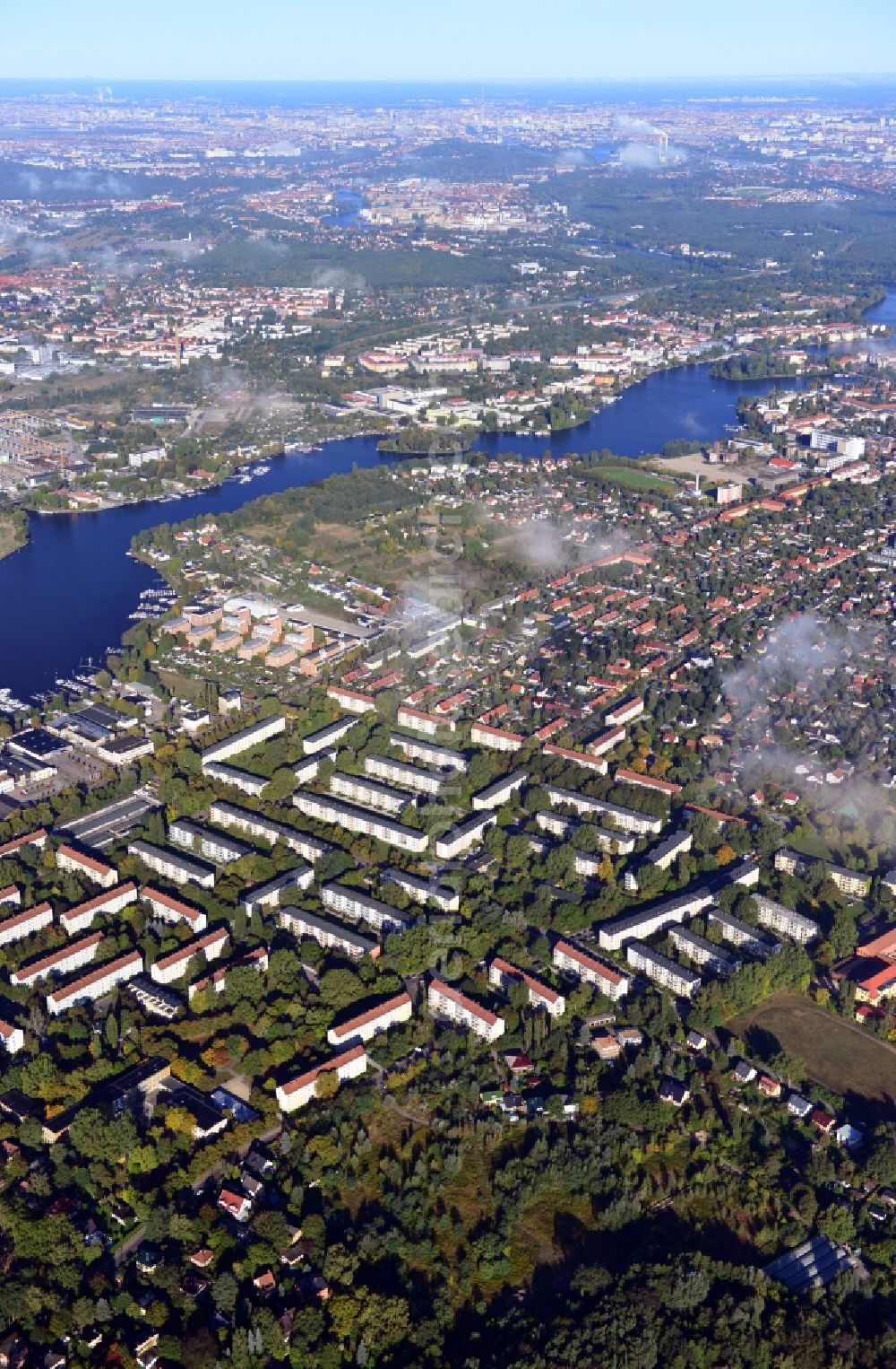 Berlin from the bird's eye view: Cityscape traversed by clouds overlooking the autumnal district of Koepenick along the river Dahme witha view of the Rohrwall-Island in Berlin. Residential areas and green space along Wendenschlossstrasse