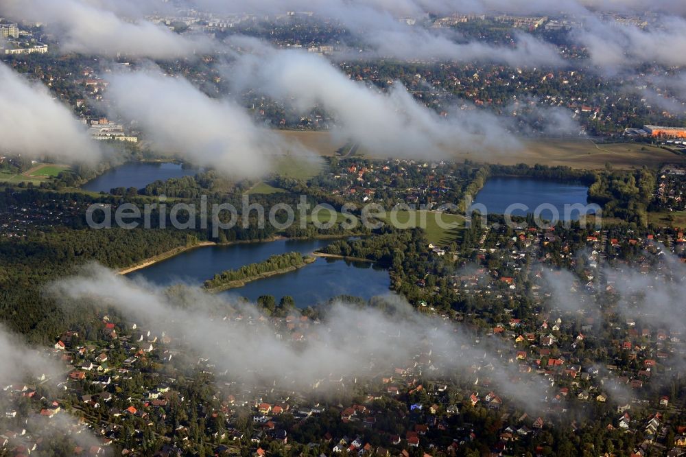 Aerial image Berlin - View of clouds circling the countryside surrounding the three Kaulsdorfer Lakes Butzer See, Elsensee and Habermannsee in Berlin - Kaulsdorf. The lakes are located in a nature preserve surrounded by localities with small houses