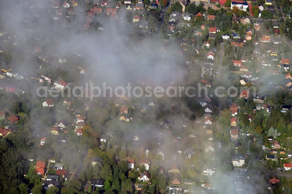 Aerial image Berlin - Cityscape traversed by clouds overlooking autumnal landscape and detached houses in a residential area of the Mahlsdorf district in Berlin