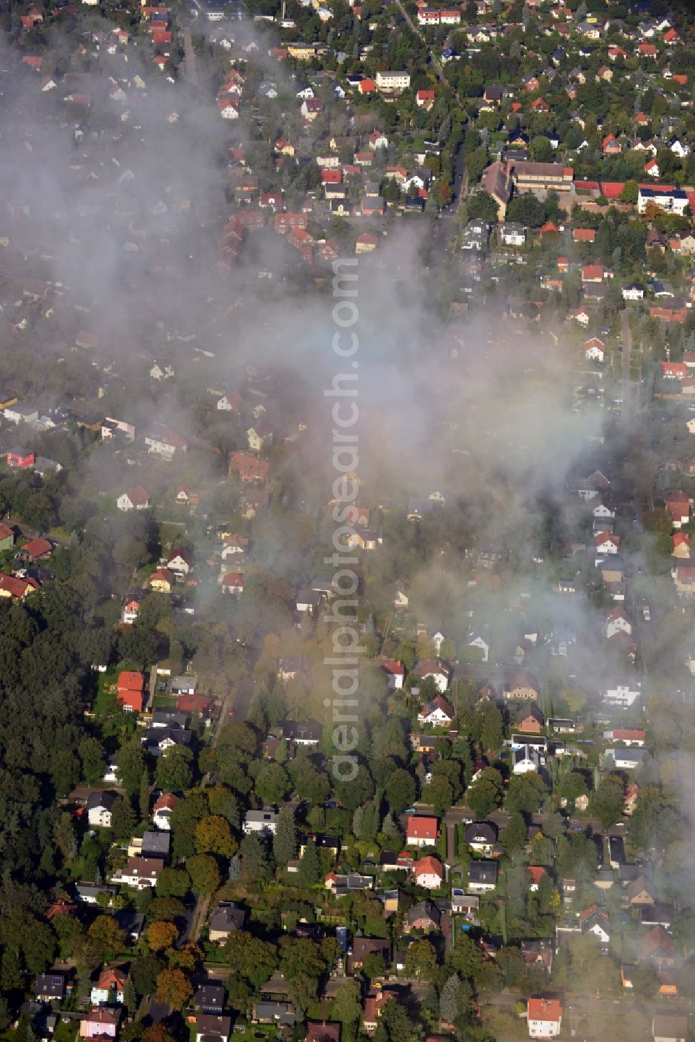 Aerial image Berlin - Cityscape traversed by clouds overlooking autumnal landscape and detached houses in a residential area of the Mahlsdorf district in Berlin