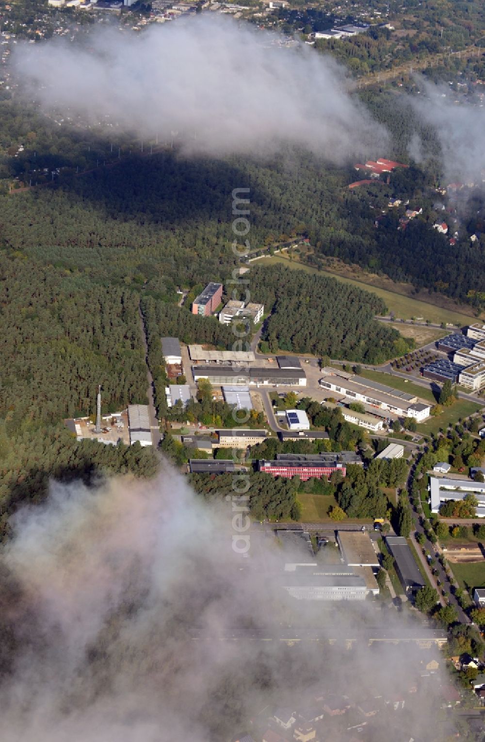 Aerial image Berlin - View of clouds surrounding the campus of commercial area Wuhlheide Innovation Park in Berlin - Koepenick. The industrial area at Verlaengerte Kopenicker Strasse is location of many predominantly technology-oriented companies from various business branches. Operator is the Innovationspark Wuhlheide Managementgesellschaft mbH