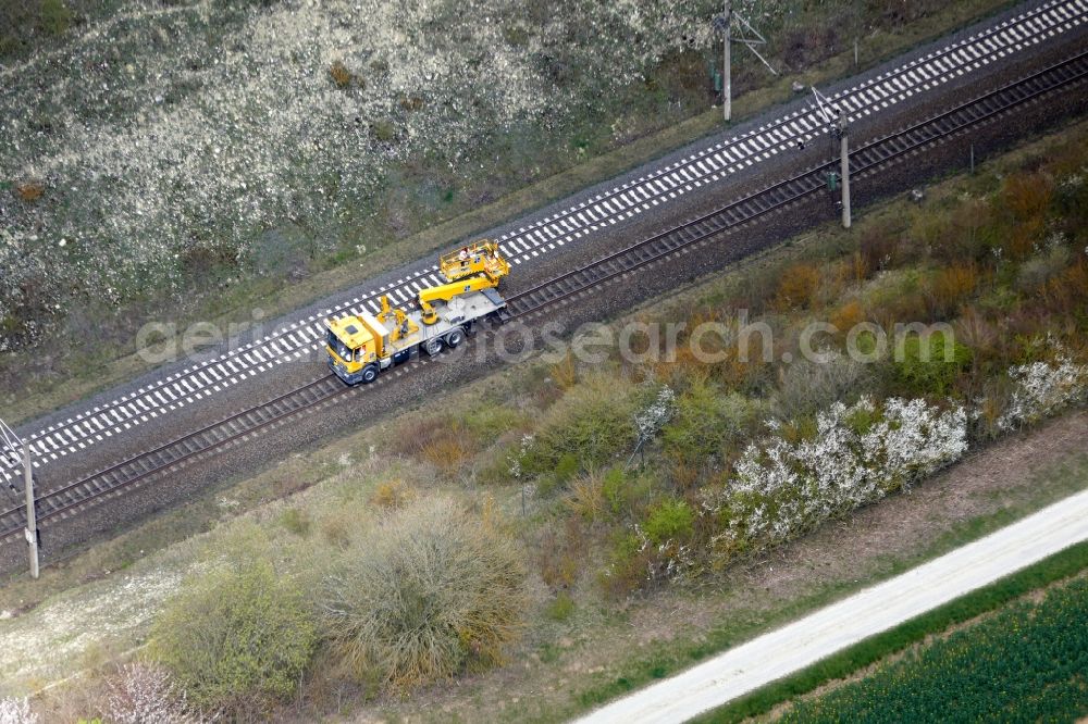 Jühnde from above - Maintenance work on a rail track and overhead wiring harness in the route network of the Deutsche Bahn in Juehnde in the state Lower Saxony, Germany