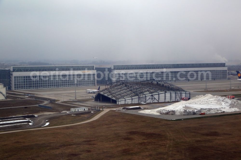 München-Flughafen from above - Hangar, maintenance hall, noise protection hall an deposit area for snow and ice on the grounds of the airport in Muenchen-Flughafen in the state Bavaria, Germany