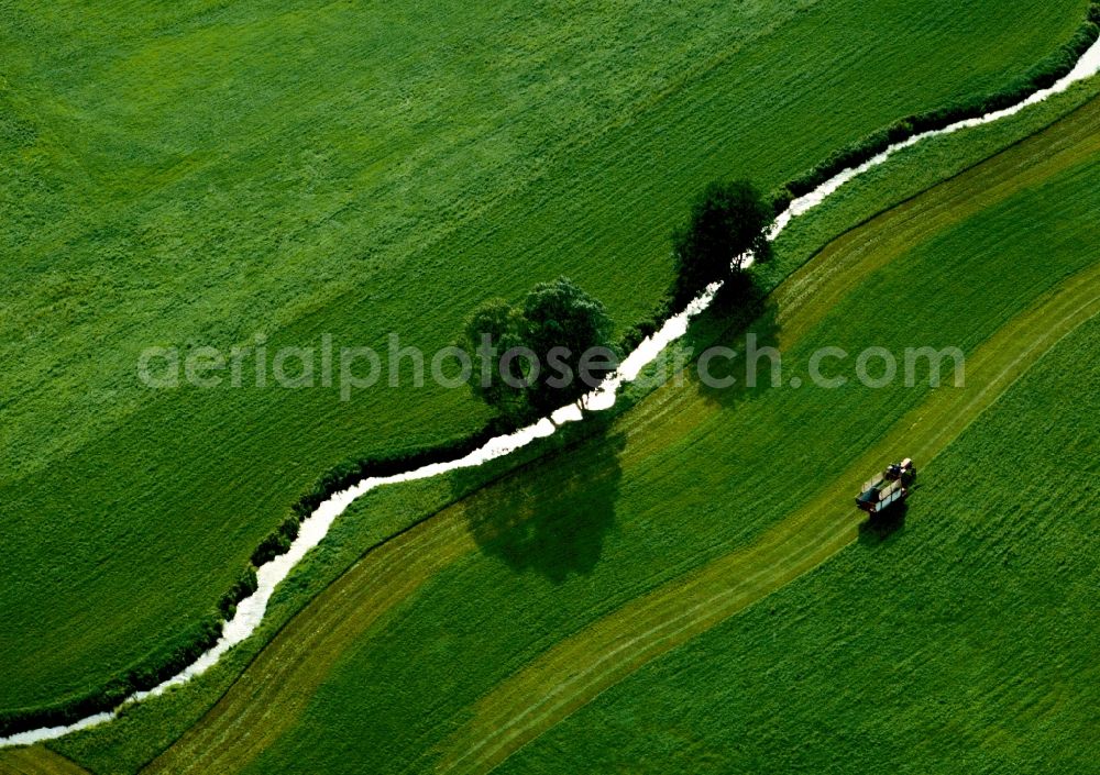 Aerial photograph Ansbach - Wasenbach creek, fields and tractor in the borough of Ansbach in the state of Bavaria. The creek is located between fields and takes its course through the landscape of the district of Middle Franconia. The sun is reflected in the narrow creek