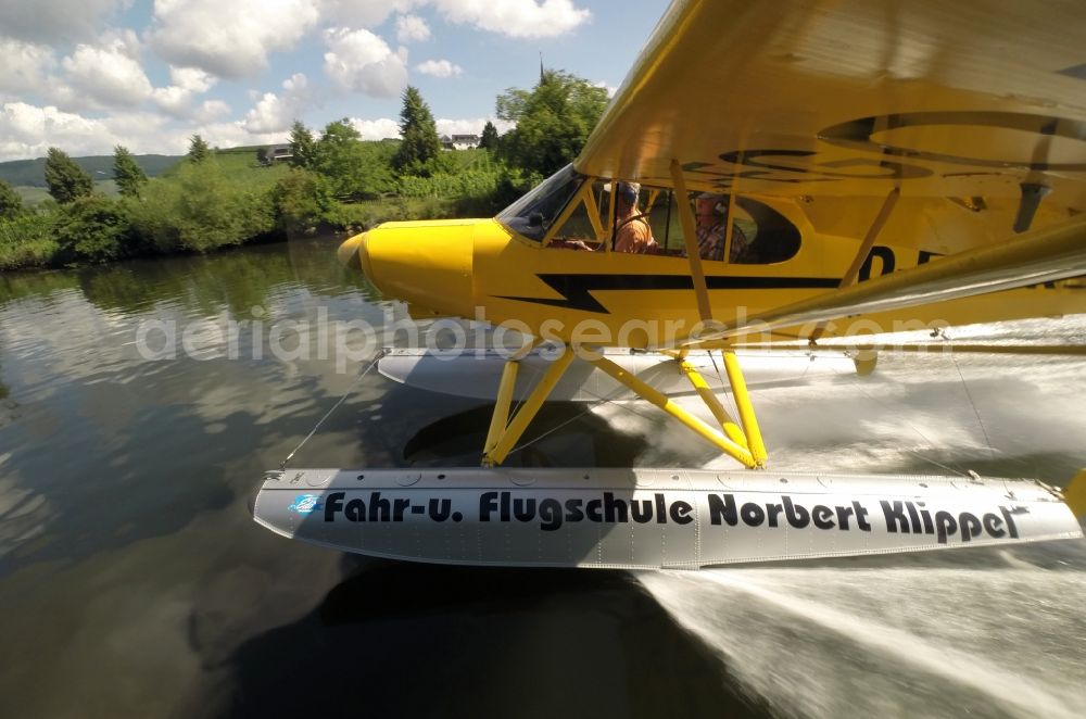 Aerial photograph Zeltingen-Rachtig - Seaplane Piper PA-18 Super Cub on the Moselle with pines in Zeltingen in the state Rhineland-Palatinate. No use for reports on aviation accidents