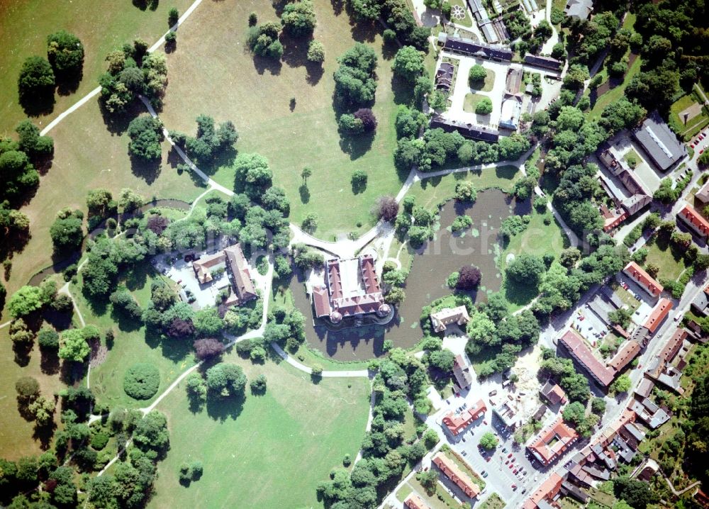 Bad Muskau from above - Building and castle park systems of water castle on Schlossstrasse in Fuerst-Pueckler-Park in Bad Muskau in the state Saxony, Germany