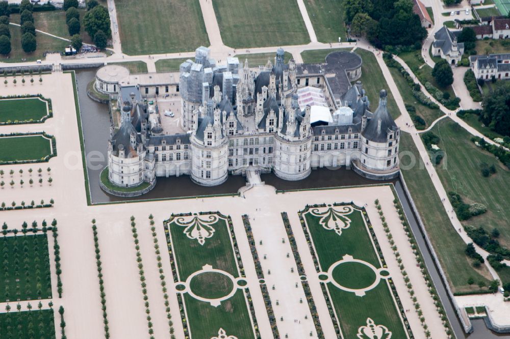 Aerial image Chambord - Building and castle park systems of water castle Chateau de Chambord on street Le Chateau in Chambord in Centre-Val de Loire, France