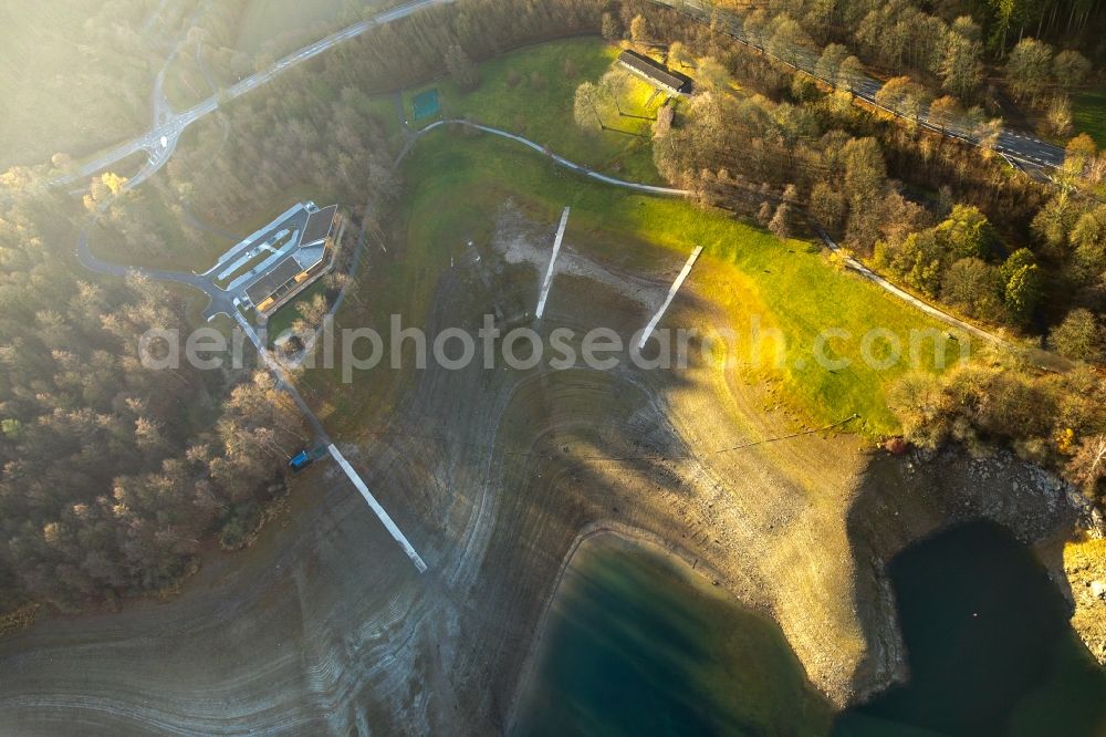 Meschede from above - Low water level and lack of water caused the shoreline areas to be exposed of lake Hennesee in Meschede in the state North Rhine-Westphalia, Germany