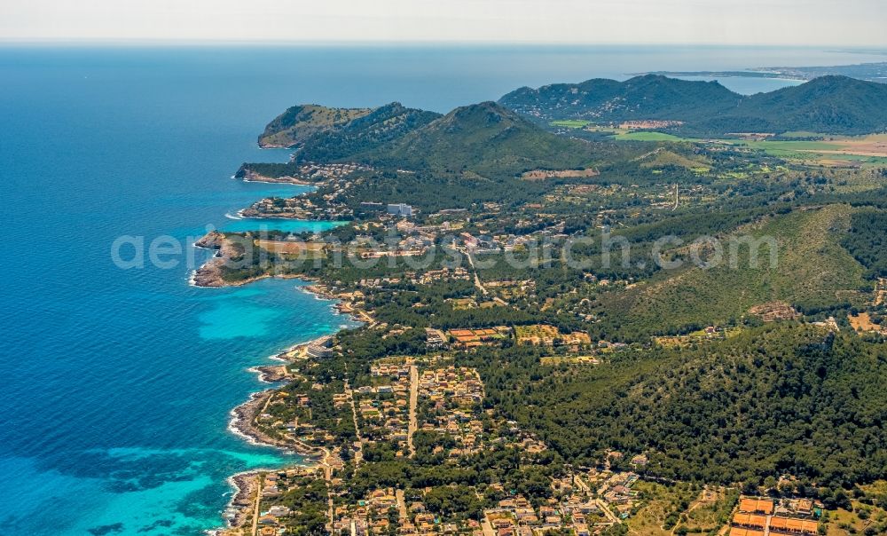 Aerial image Pedruscada - Water surface at the seaside bei of Bucht Cala of Tamarells in Pedruscada in Balearic island of Mallorca, Spain