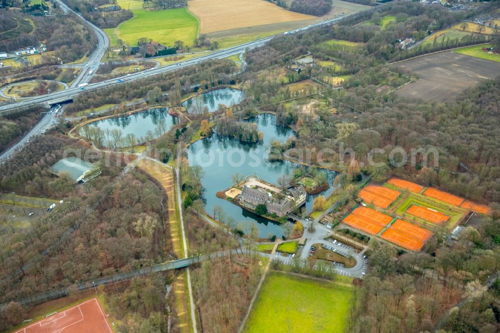 Gladbeck from the bird's eye view: Autumnal surrounding landscape of the water castle Wittringen in the South of Gladbeck in the state of North Rhine-Westphalia. The castle is located adjacent to ponds and waters near tennis courts