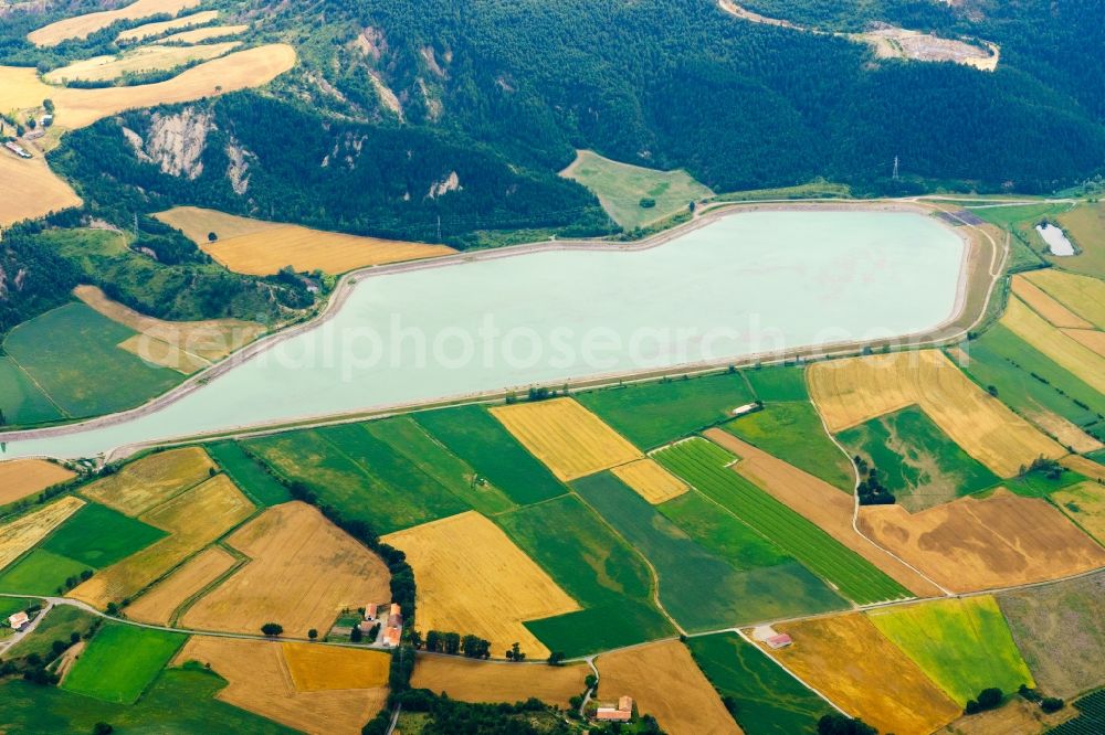 Lazer from the bird's eye view: Water reservoir and lake for agricultural irrigation in summer from melting water in Lazer in Provence-Alpes-Cote d'Azur, France