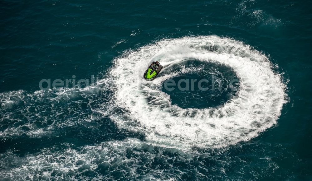 Aerial image Agde - By waves and foam crests of watersports curves and circular drive with turbulence Mediterranean surface water off the coast in Agde in France
