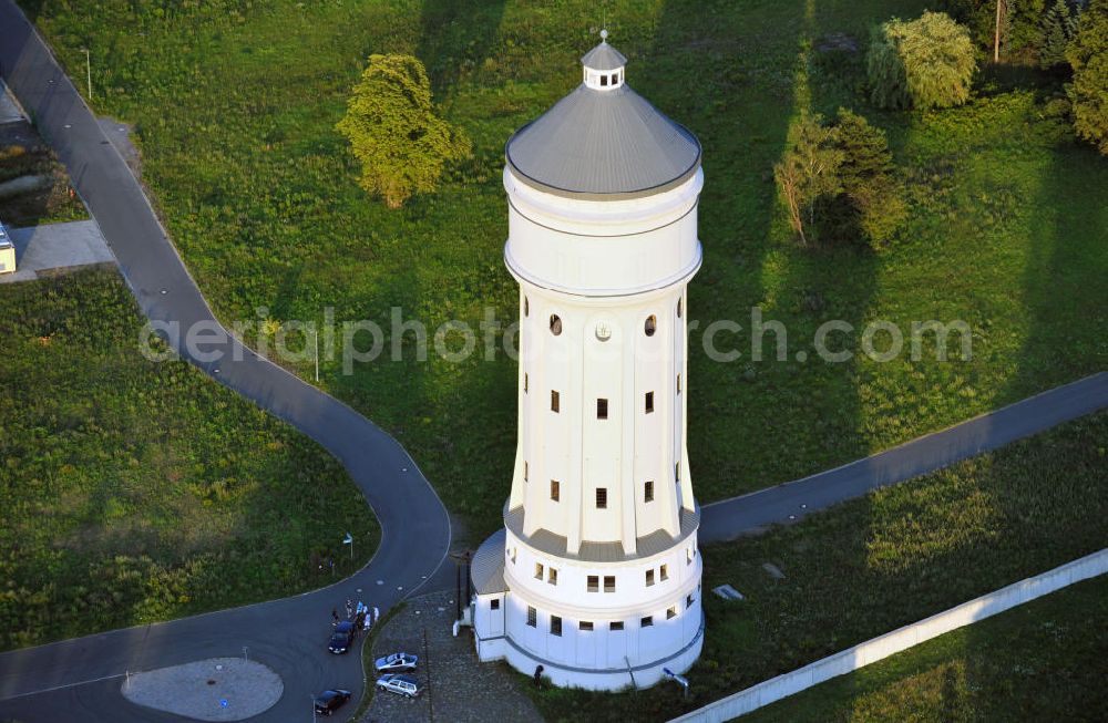 Aerial image Eilenburg - Der etwa 60 Meter hohe Wasserturm in Eilenburg-Ost in Sachsen wurde 1916 in der aufwendigen Bauart Otto Intzes vom Unternehmen Dyckerhoff und Widmann AG für die große Zelluloidfabrik gebaut. Nachdem er in der Zeit der DDR immer mehr verfallen war, wurde er im Jahr 2002 wieder instandgesetzt. Der Turm dient nun als Löschwasserspeicher für das benachbarte Industrie- und Gewerbegebiet Kunstoffcenter am ECW-Wasserturm und gilt als das wohl eindrucksvollste technische Denkmal der Stadt. About 60 metres high water tower in Eilenburg-East in Saxony was build 1916 in elaborate style of Otto Intzes by company Dyckerhoff und Widmann AG for a big celluloid factory. Gone to rack during the time of DDR, the tower was refurbished in 2002. It now serves as a fire water reservoir for industrial area Kunstoffcenter am ECW-Wasserturm nearby and is regarded as the most impressive technical monument of the town.