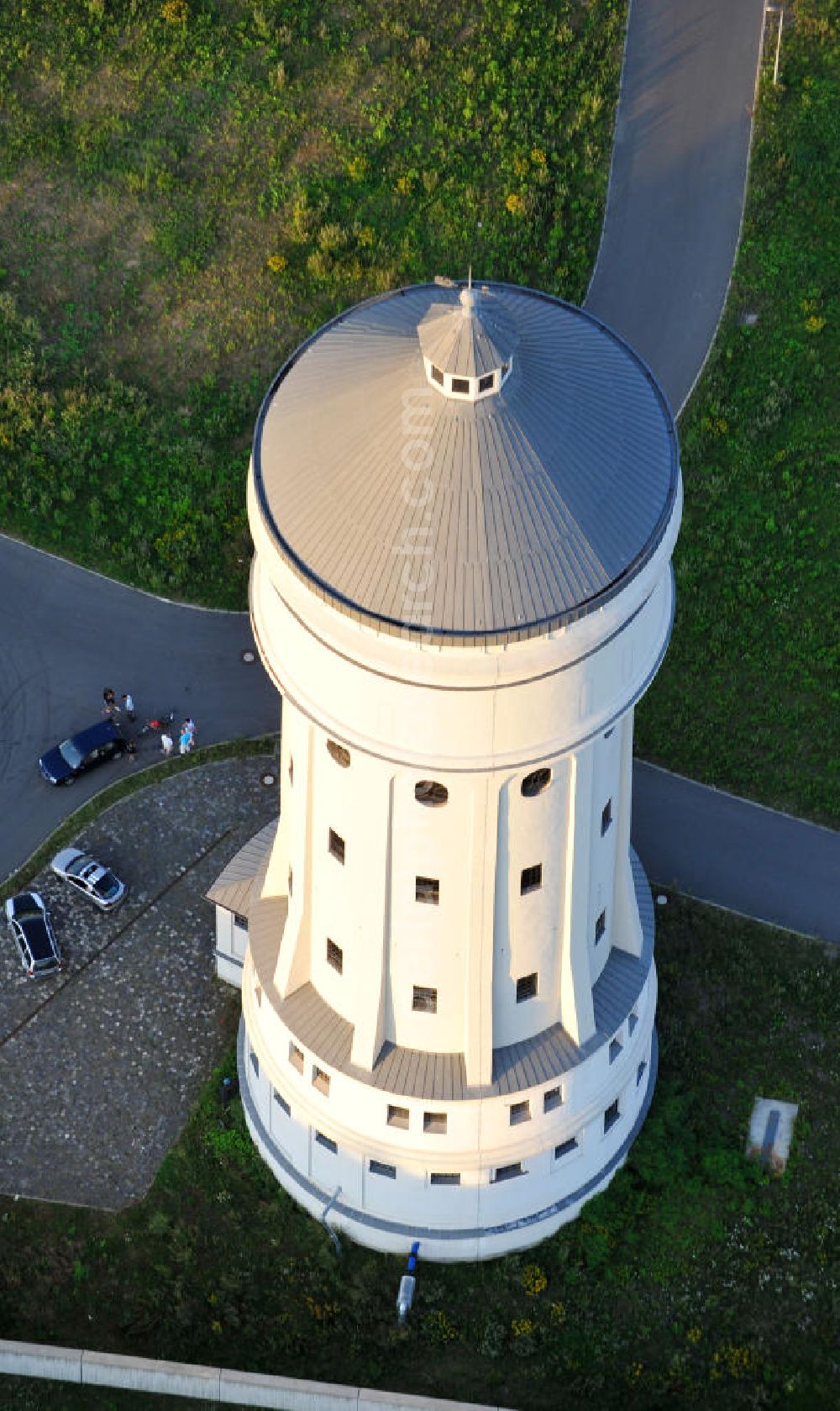 Eilenburg from the bird's eye view: Der etwa 60 Meter hohe Wasserturm in Eilenburg-Ost in Sachsen wurde 1916 in der aufwendigen Bauart Otto Intzes vom Unternehmen Dyckerhoff und Widmann AG für die große Zelluloidfabrik gebaut. Nachdem er in der Zeit der DDR immer mehr verfallen war, wurde er im Jahr 2002 wieder instandgesetzt. Der Turm dient nun als Löschwasserspeicher für das benachbarte Industrie- und Gewerbegebiet Kunstoffcenter am ECW-Wasserturm und gilt als das wohl eindrucksvollste technische Denkmal der Stadt. About 60 metres high water tower in Eilenburg-East in Saxony was build 1916 in elaborate style of Otto Intzes by company Dyckerhoff und Widmann AG for a big celluloid factory. Gone to rack during the time of DDR, the tower was refurbished in 2002. It now serves as a fire water reservoir for industrial area Kunstoffcenter am ECW-Wasserturm nearby and is regarded as the most impressive technical monument of the town.