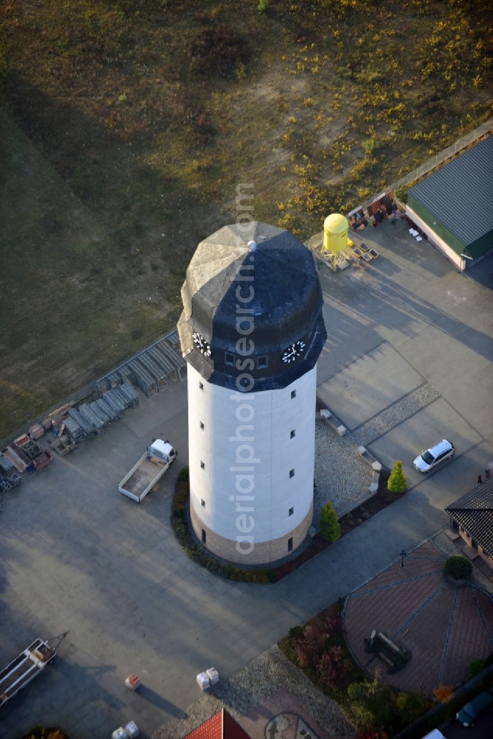 Aerial photograph Premnitz - View onto the water tower of Premnitz in the state Brandenburg. The water tower was once the industrial water reservoir of the production of gunpowder and later the production of rayon staple and chemical fibre. Today the tower houses an exhibition of Premnitz' industrial history